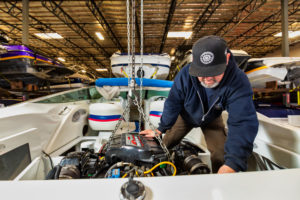 mechanic putting engine into boat at Homewood High and Dry Marina