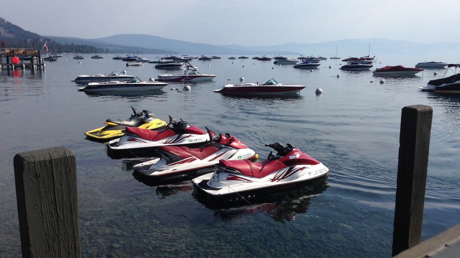 Four jet skis parked off the pier on tahoe